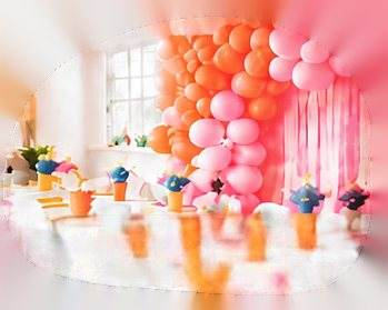Birthday party setup with a balloon arch